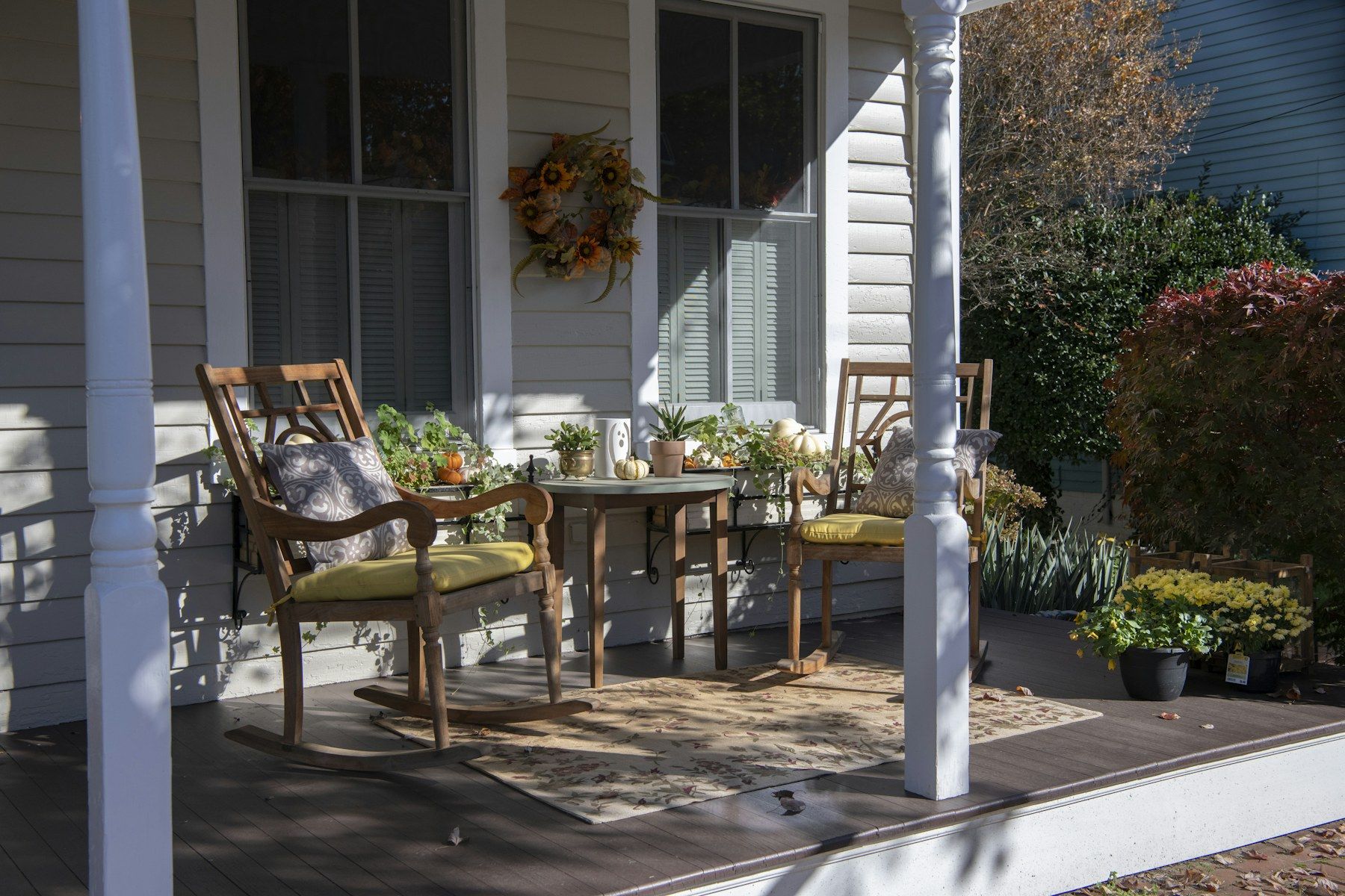 A front porch with chairs and a table